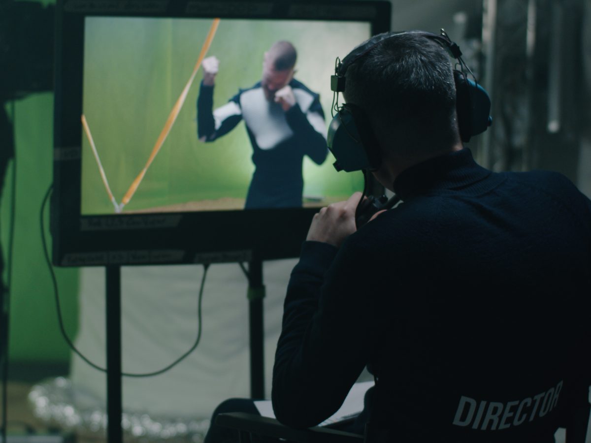 Director at the playback monitor reviewing a take during post-production