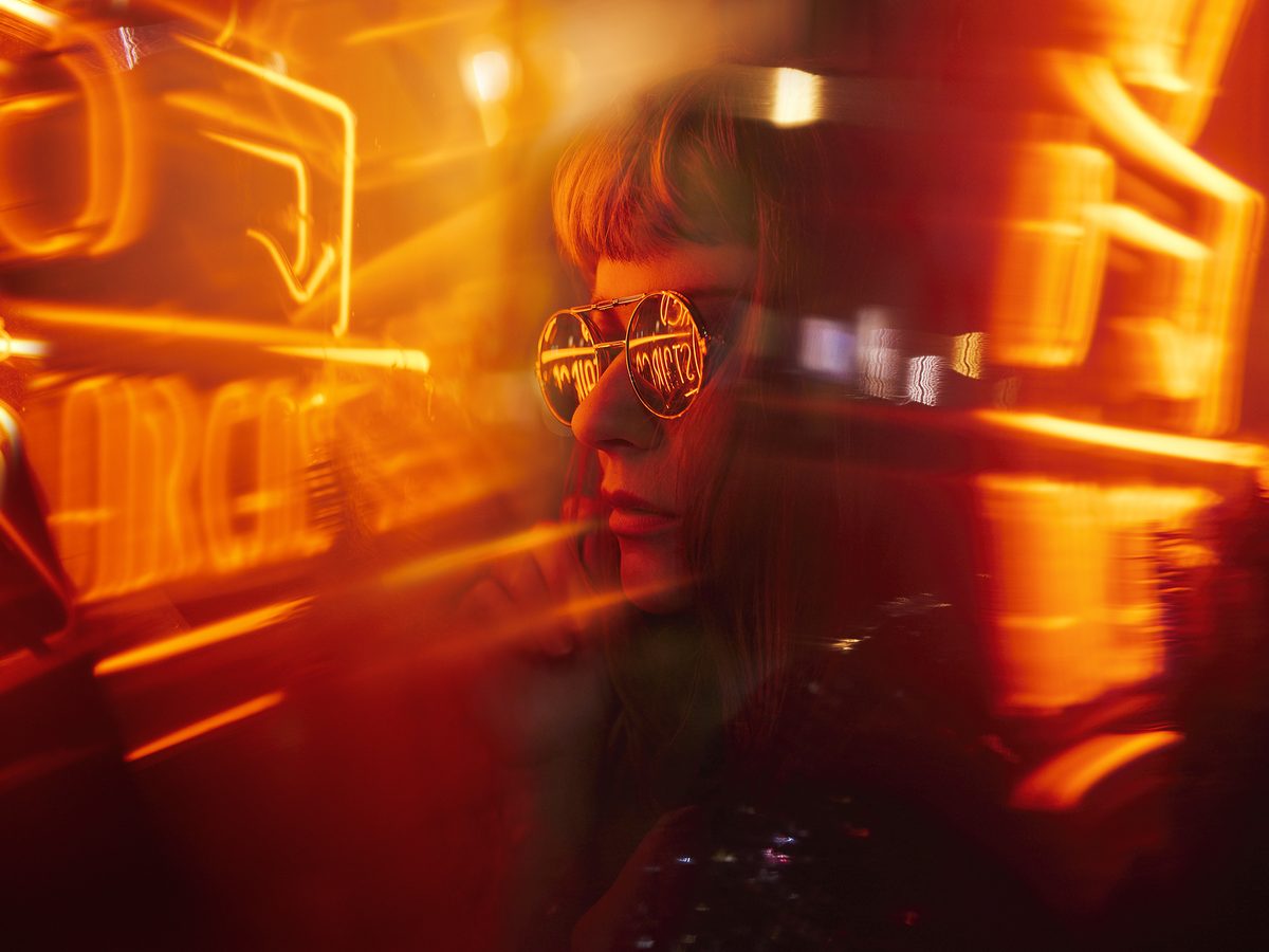 Neon-lit cinematic still — the licensed work in the world after the wrap